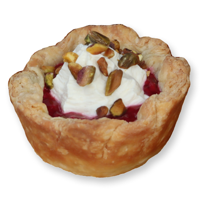 Cherry hand pie, with whip cream and pistachios